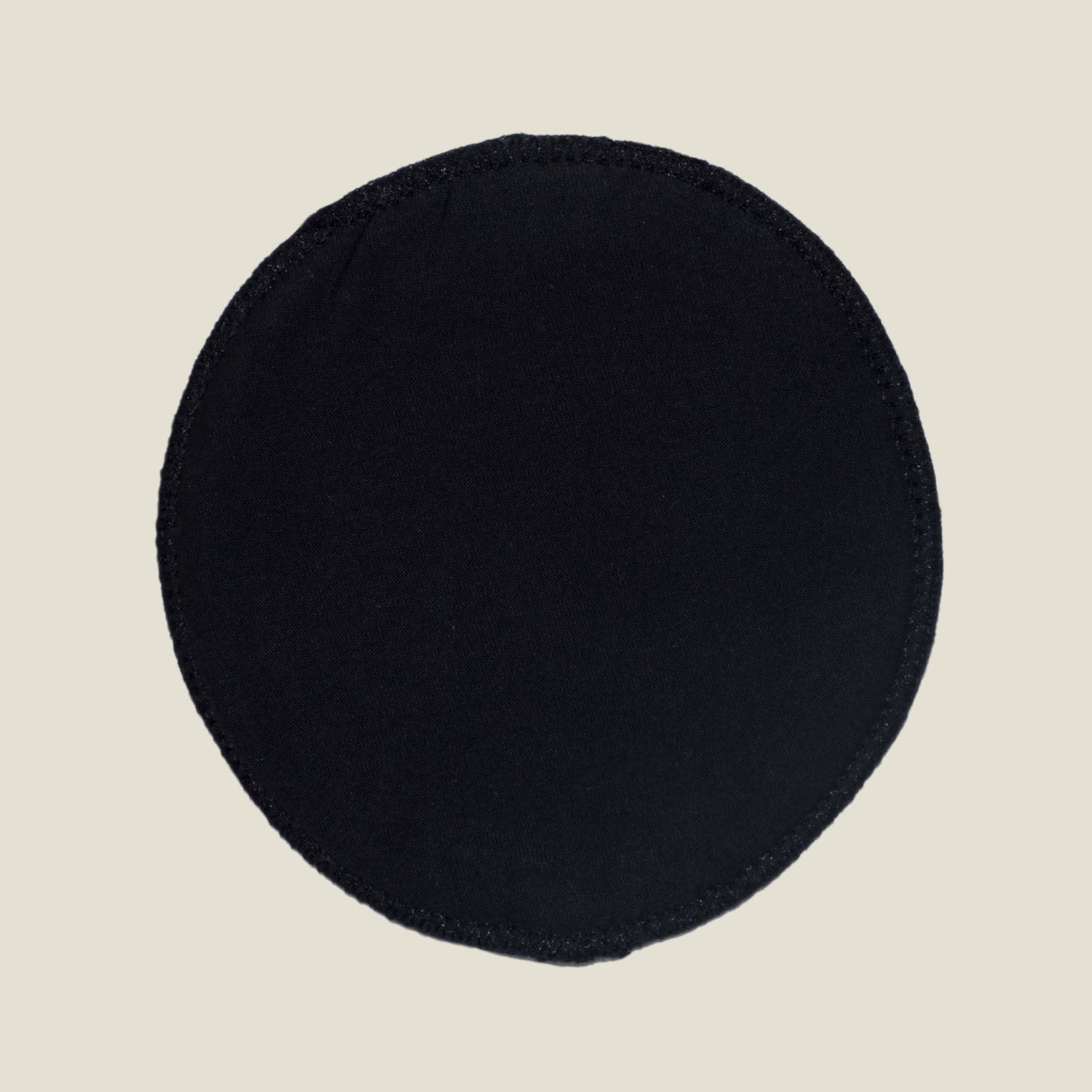 WUKA Maternity Nursing Pad inner side featuring smooth, absorbent black organic cotton for gentle skin contact.