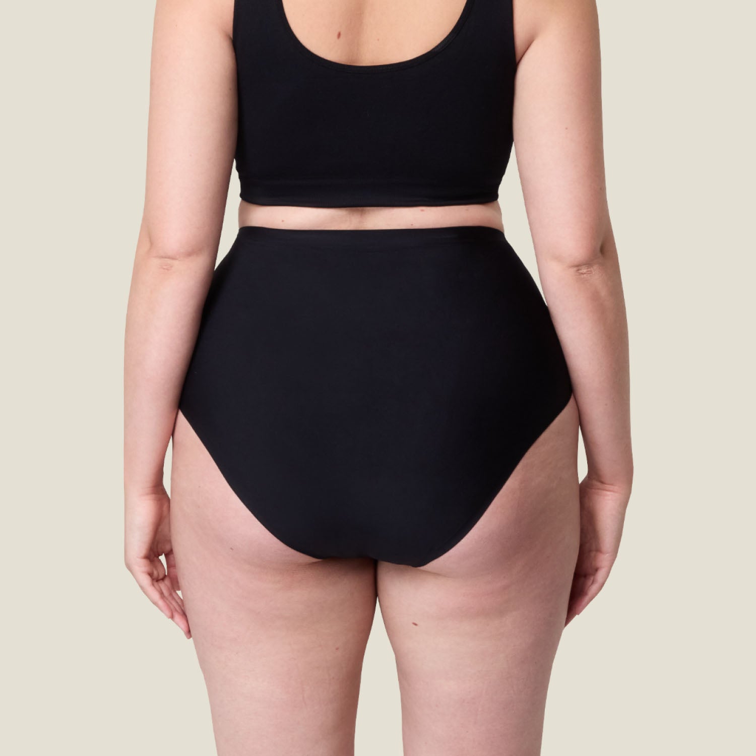 Rear view of the black WUKA Stretch™ High Waist Period Pants, showing seamless design and full-coverage fit for heavy period protection.
