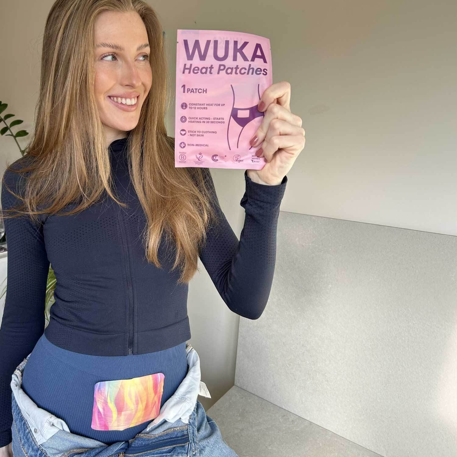 Model smiling while wearing a WUKA Heat Patch under jeans, demonstrating discreet comfort during periods.