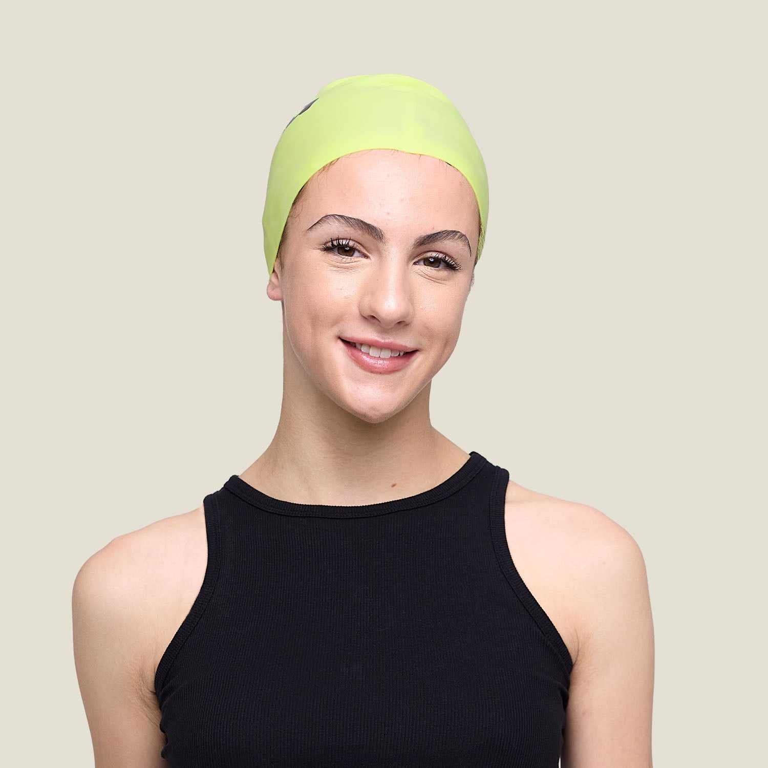 WUKA Lunafly lime punch silicone swim cap, worn by a teen swimmer — full length.