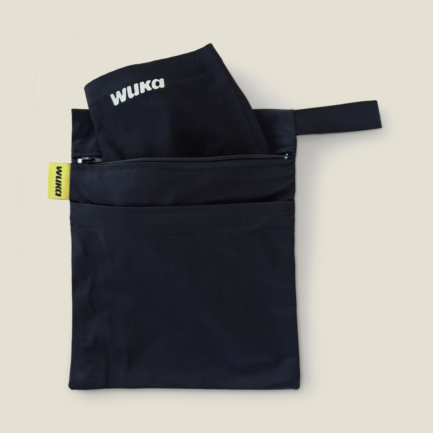WUKA waterproof two-pocket changing bag with two zip compartments for storing clean and used period products separately.