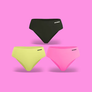 Black, green, and pink WUKA swim briefs on a pink background